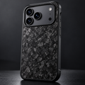 Black forged-carbon protective case on an iPhone 17 Pro Max, showing Pro camera plateau and carbon texture