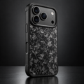 Black forged-carbon protective case on an iPhone 18 Pro, showing its Pro camera plateau and carbon texture